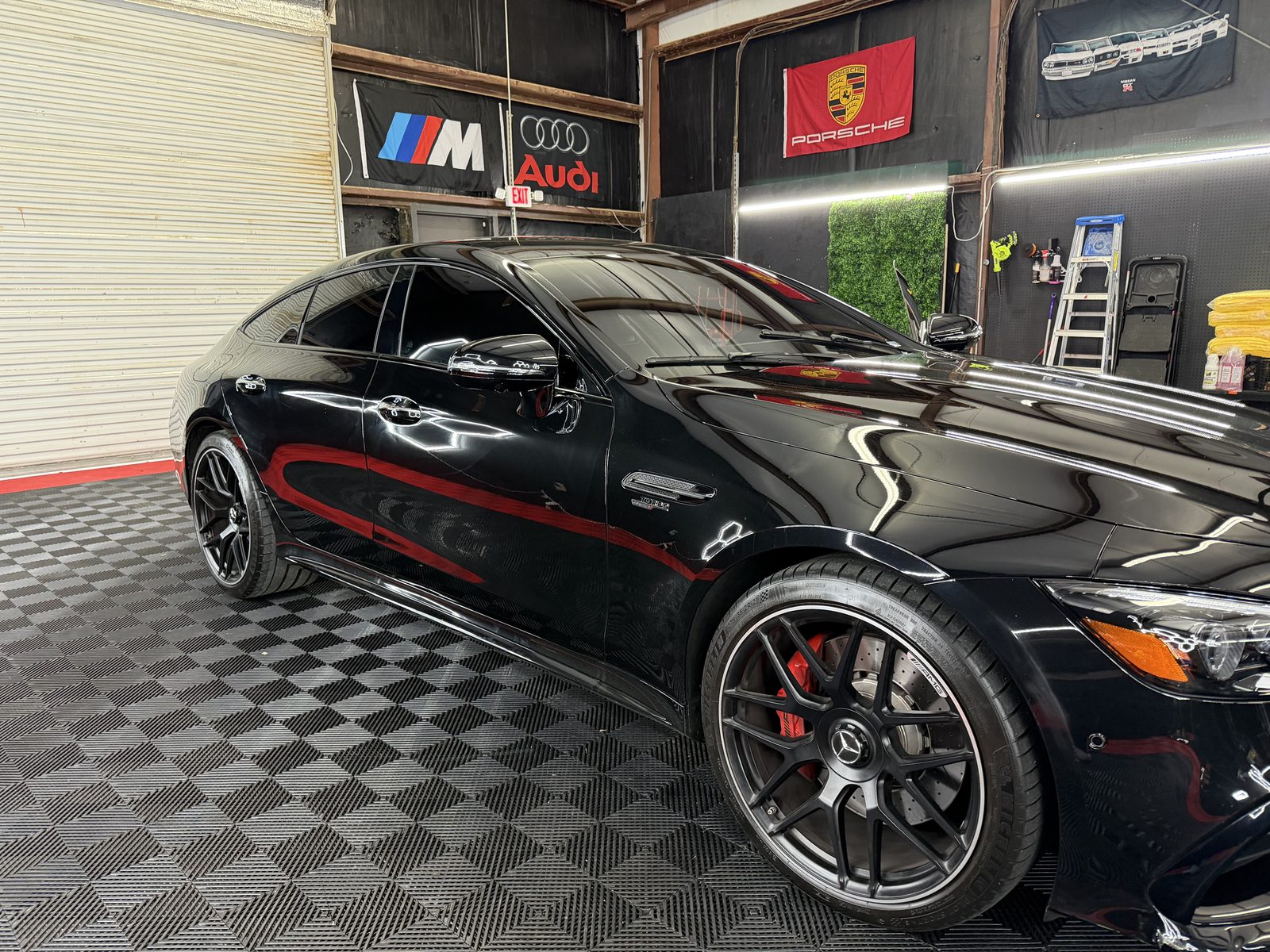 A glossy black Mercedes in the UltraHI Tintz shop